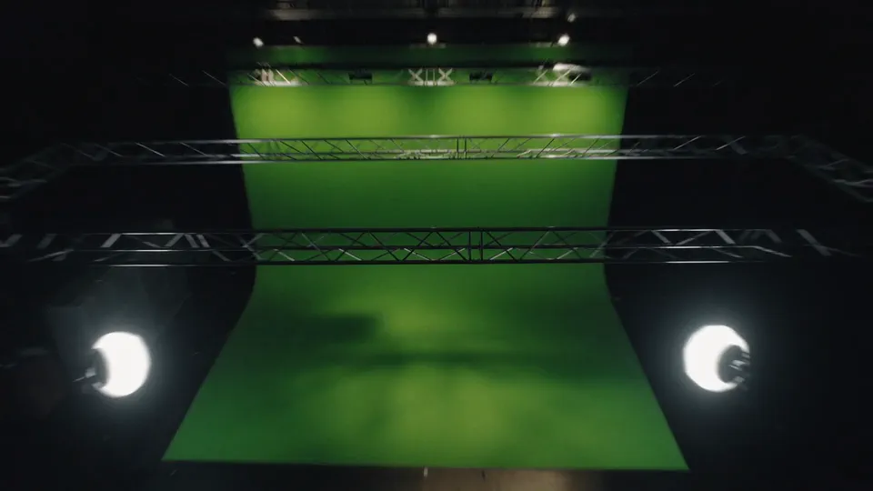 Green key studio with a chroma key cyclorama, truss and lights